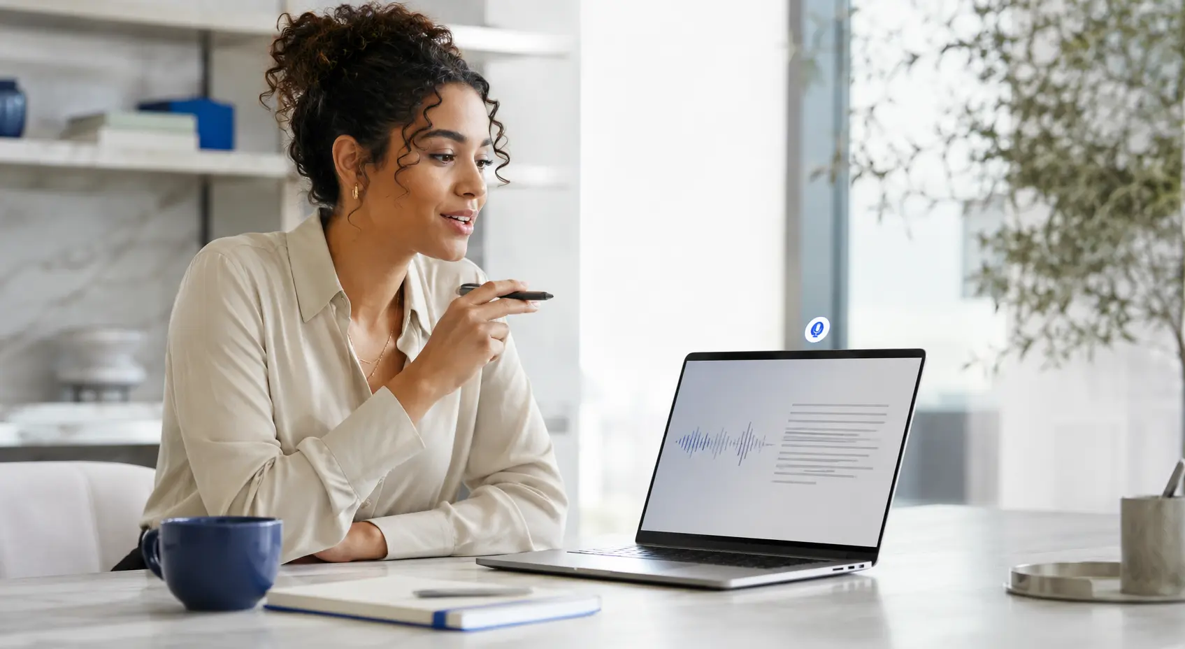 A professional using voice dictation at a laptop